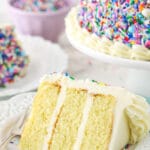 small slice of cake on white plate with blue napkin