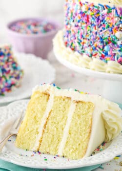 small slice of cake on white plate with blue napkin