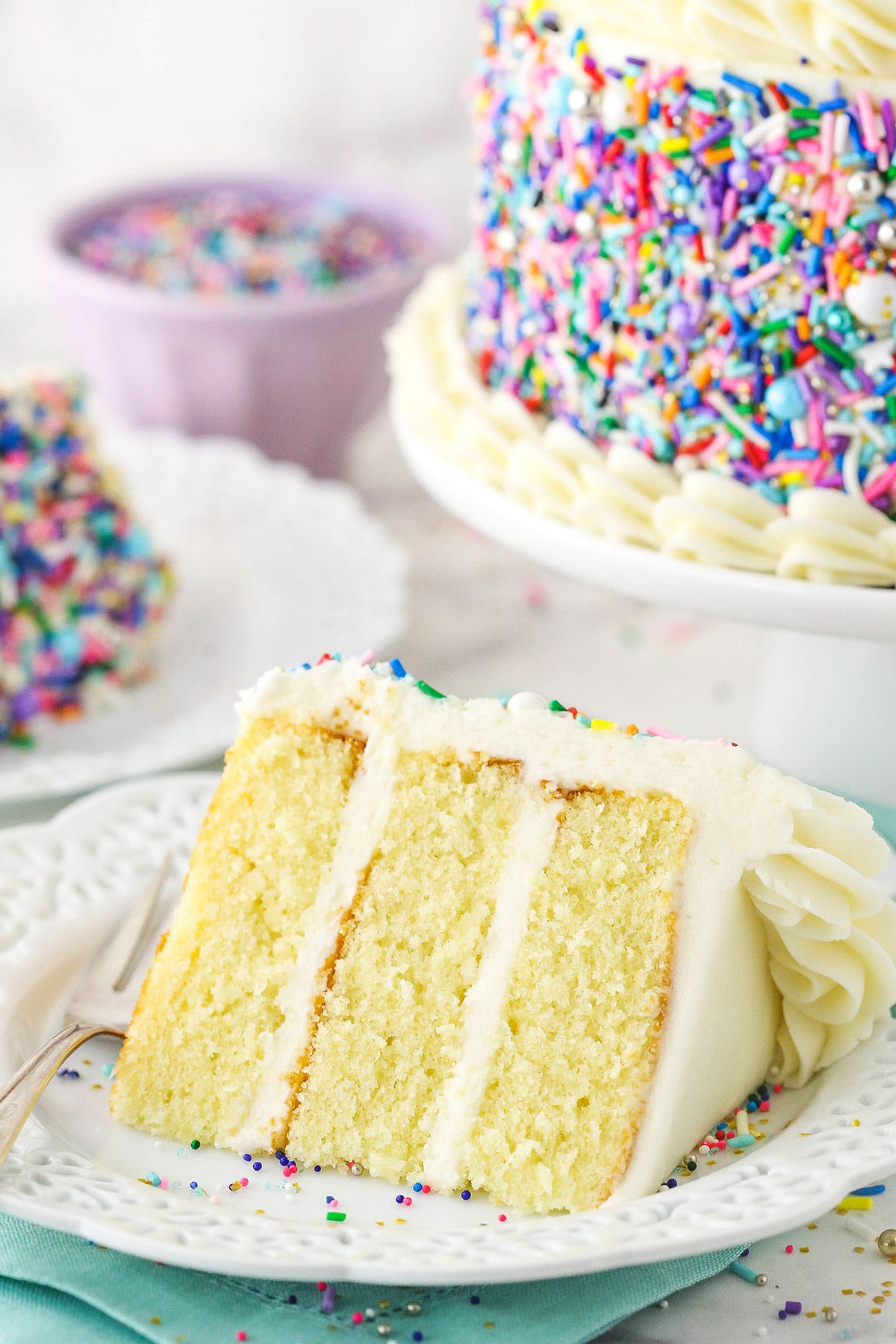 small slice of cake on white plate with blue napkin