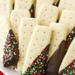 A close-up shot of chocolate covered shortbread cookies arranged on a white plate