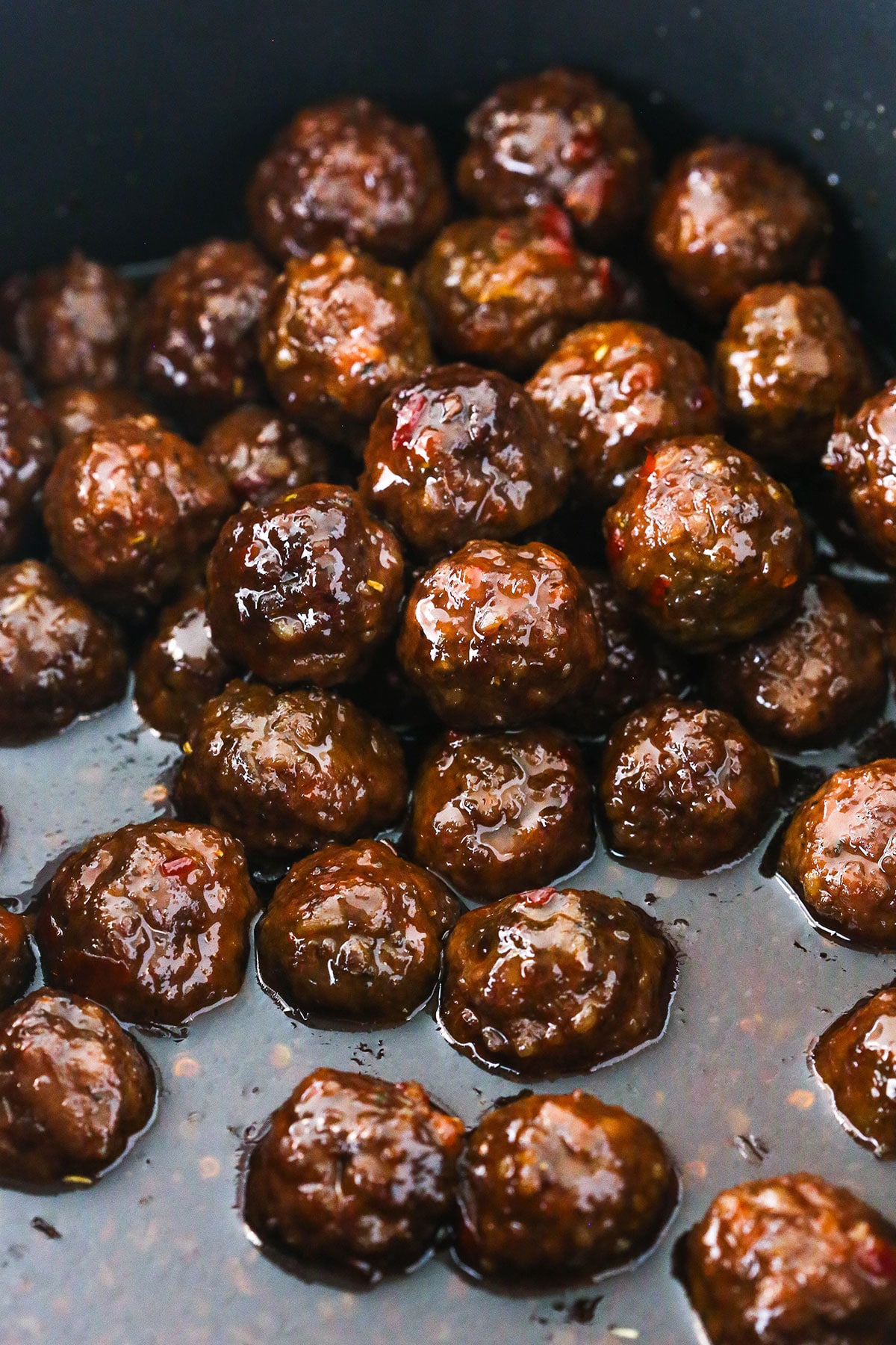 grape jelly meatballs in a pile in crock pot