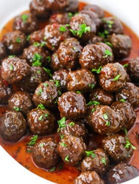 Grape Jelly Meatballs in a pile in white dish