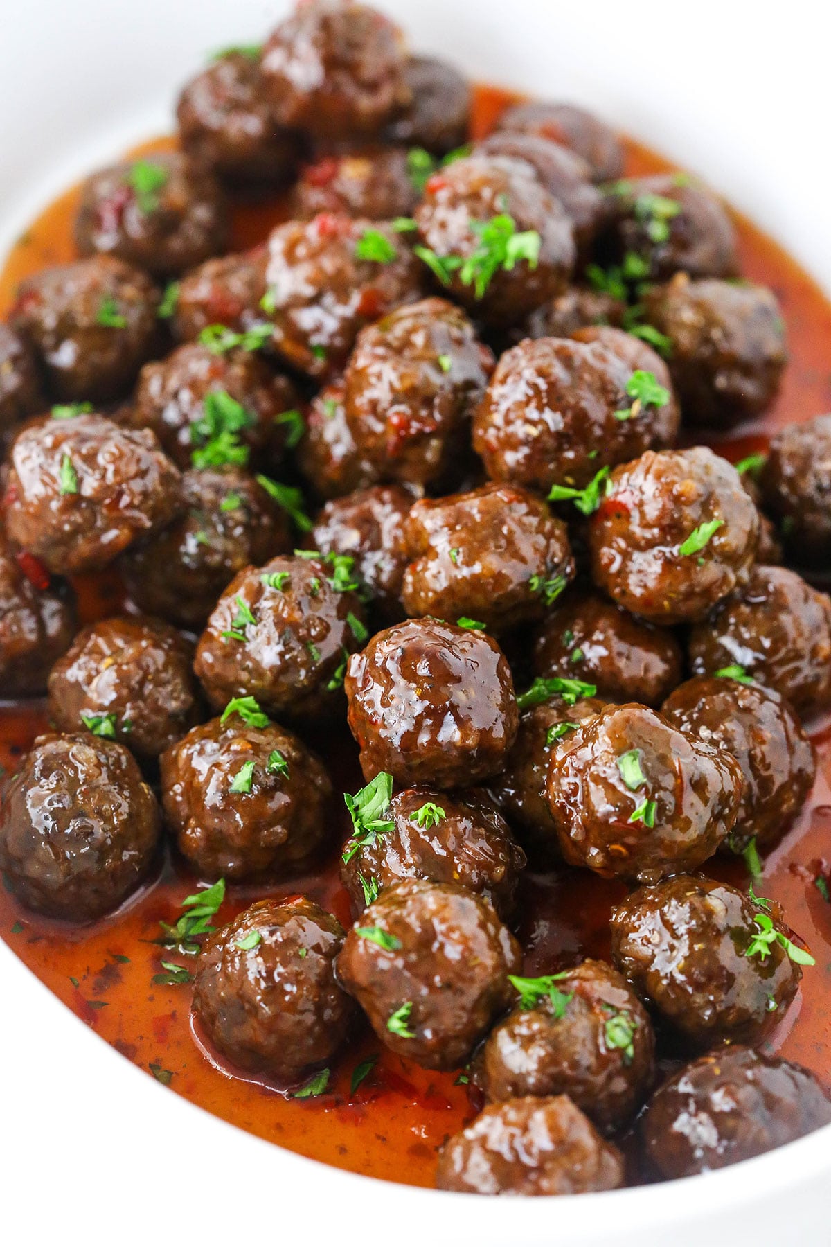 Grape Jelly Meatballs in a pile in white dish