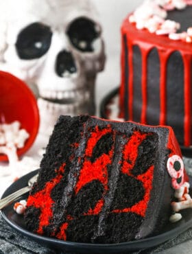 red and black. marble cake slice with skull in the background