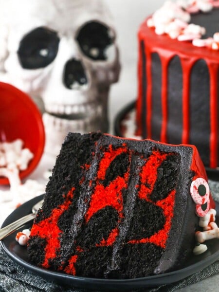 red and black. marble cake slice with skull in the background