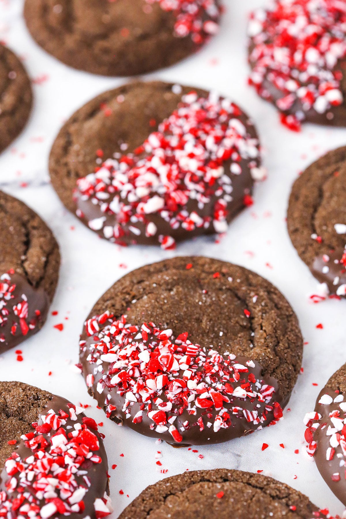 Neatly arranged peppermint chocolate sugar cookies on a marble countertop