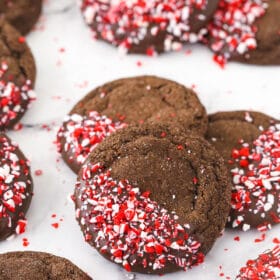 Chocolate peppermint sugar cookies arranged on a countertop in piles of three