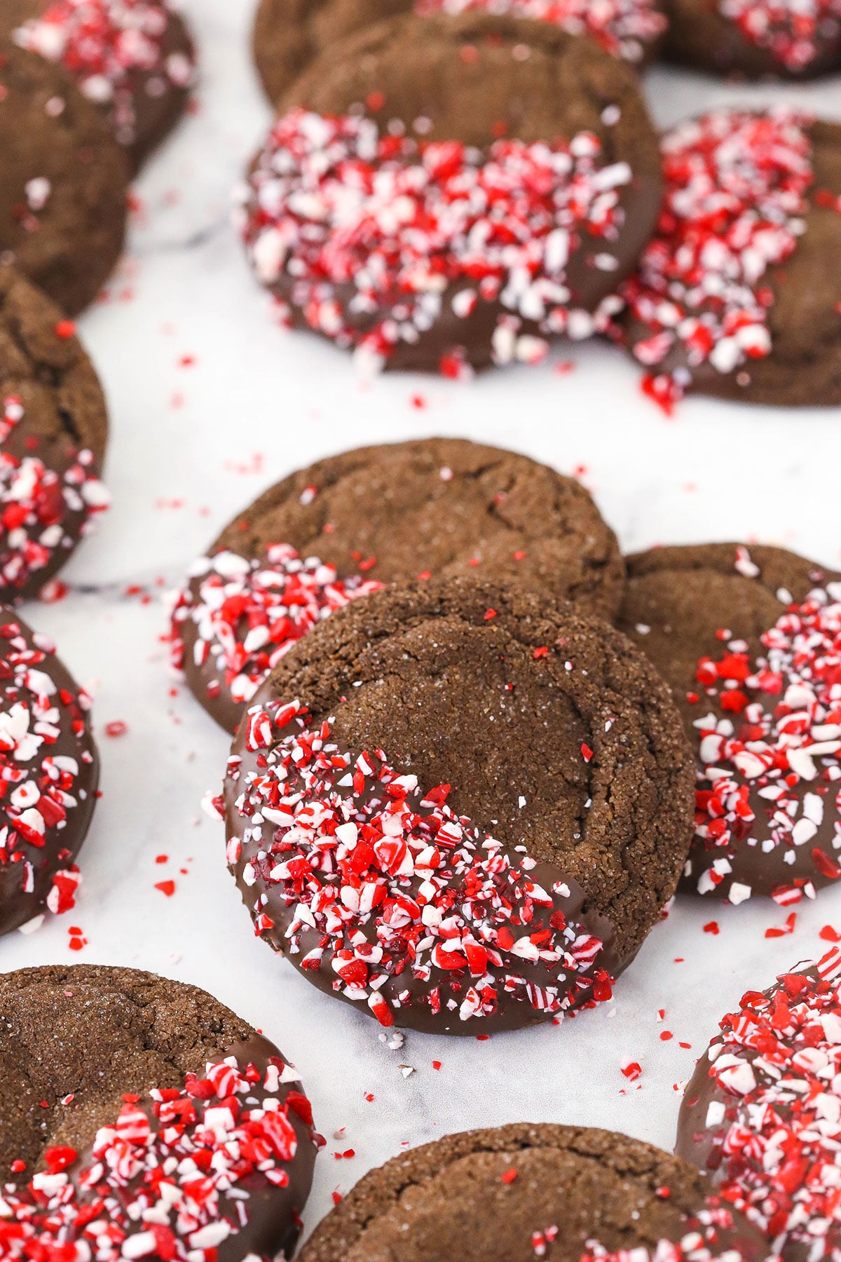 Chocolate peppermint sugar cookies arranged on a countertop in piles of three
