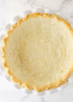 fully baked pie crust in white pie plate