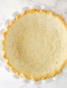 fully baked pie crust in white pie plate