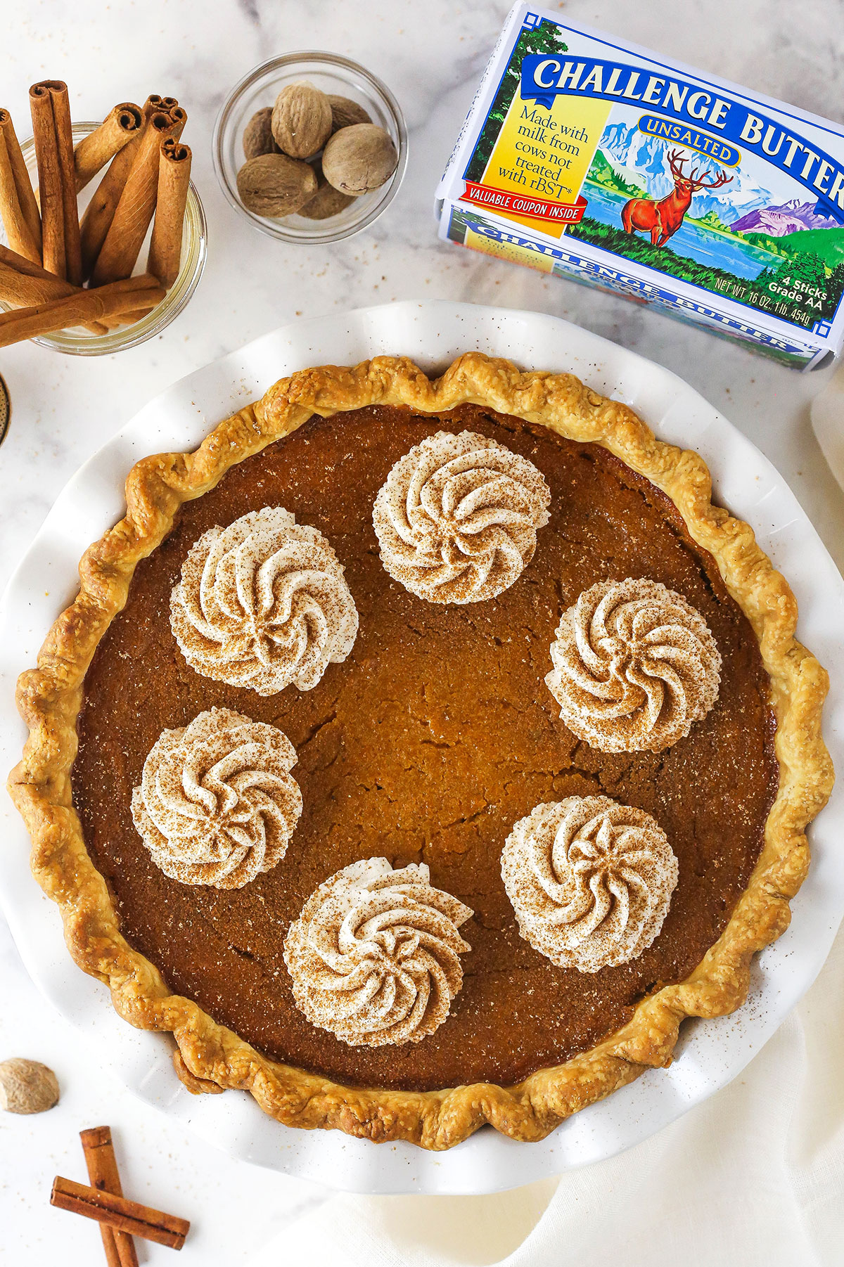 sweet potato pie in white pie plate with challenge butter