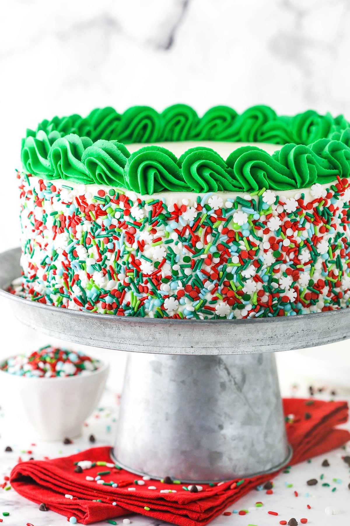 Christmas Cookie Layer Cake on metal stand and red napkin
