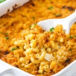 smokey beer macaroni and cheese in white casserole dish with a scoop being removed