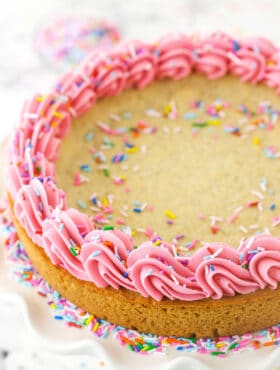 Overhead shot of a sugar cookie cake with frosting and sprinkles.