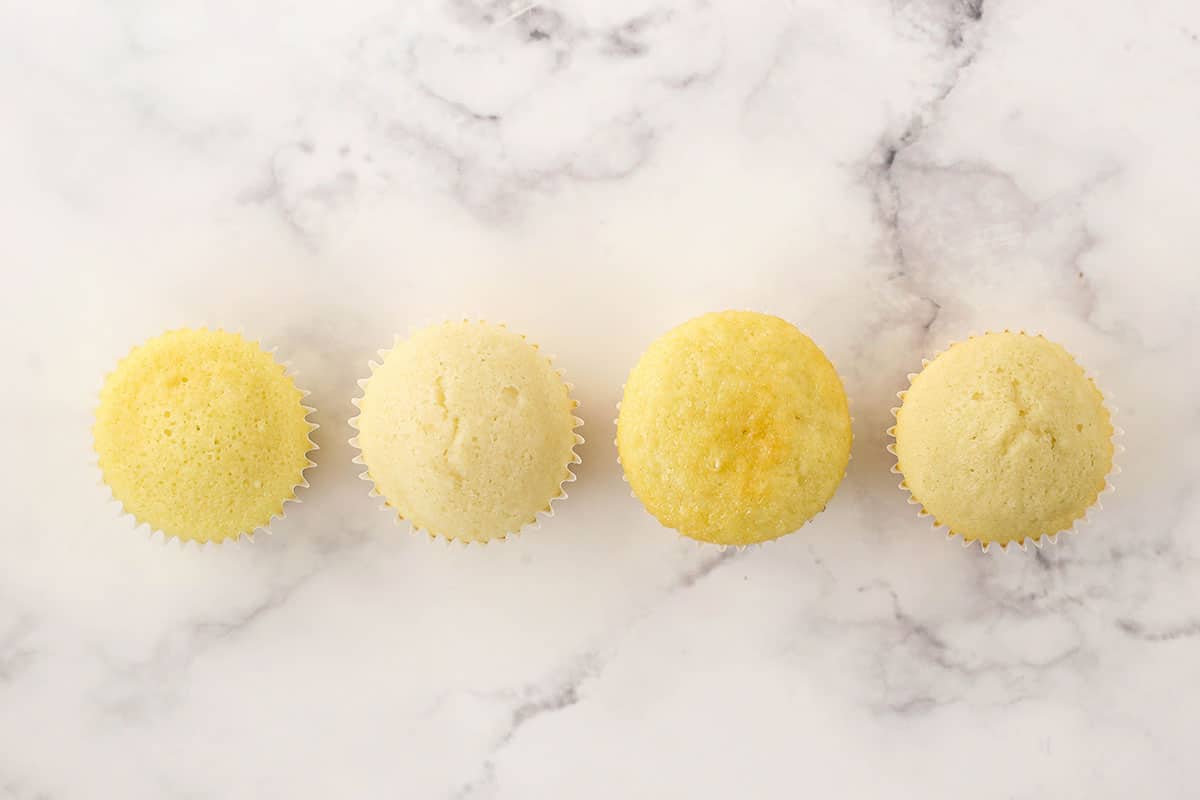 The top view of four different homemade vanilla cupcakes