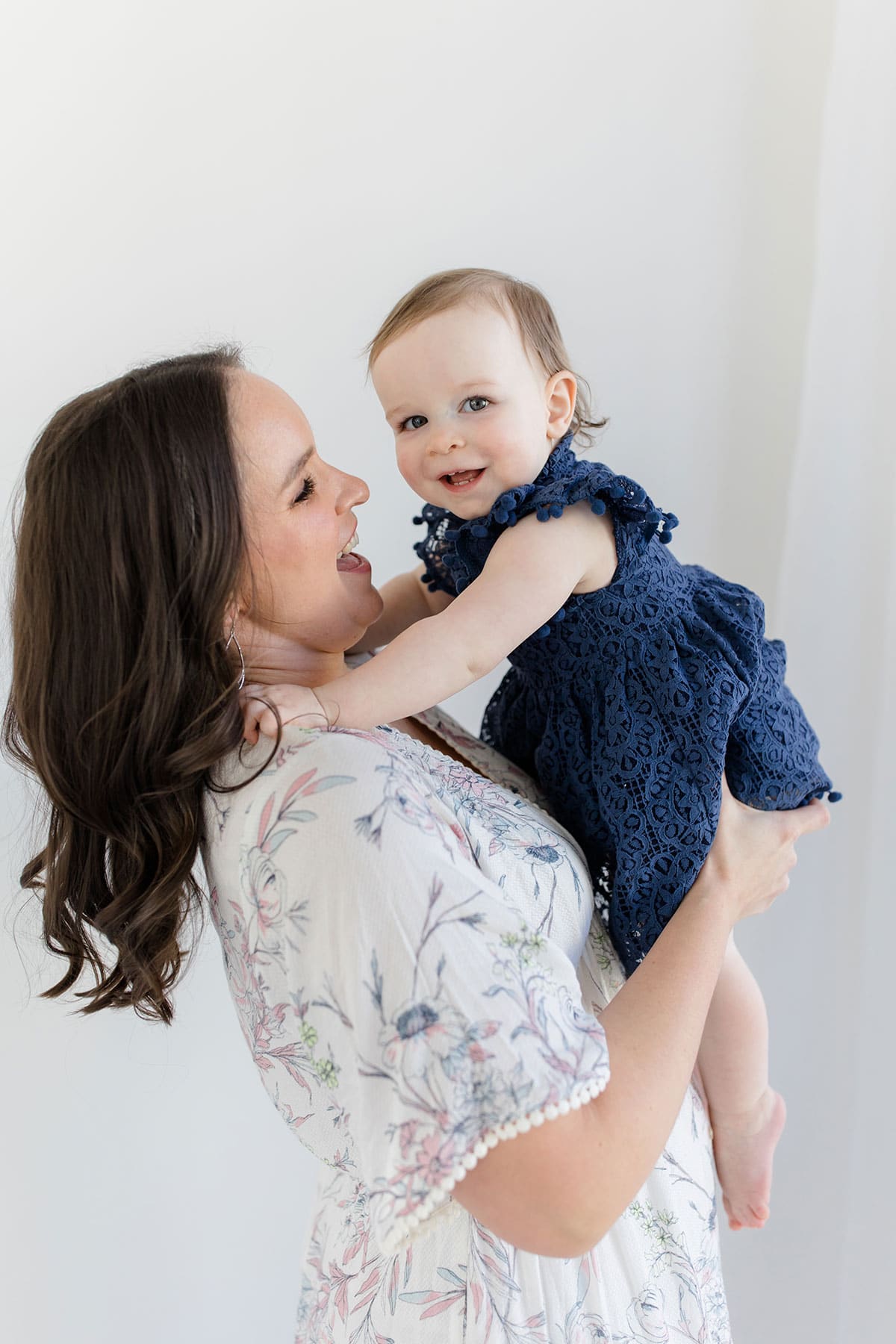 Lindsay holding McKenzie and smiling at her