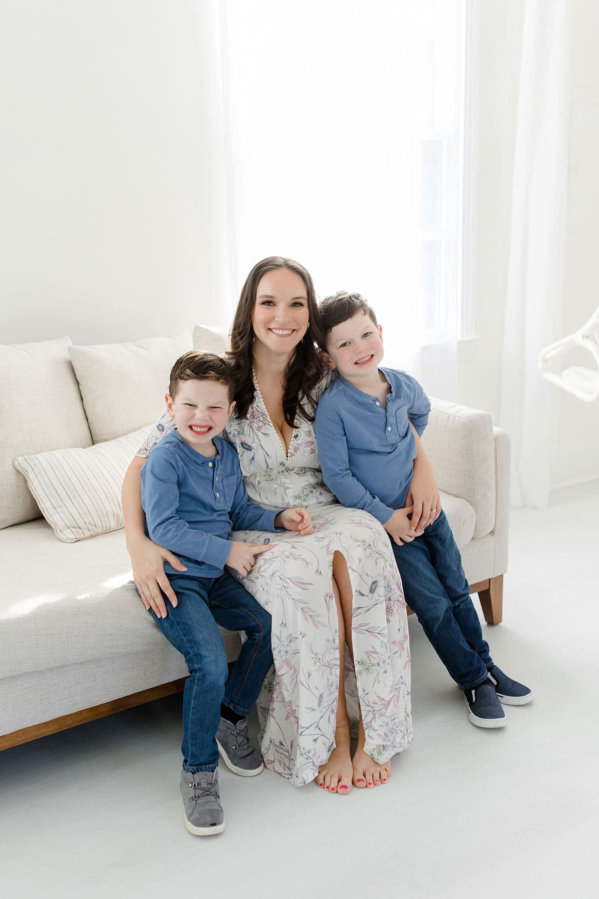 Lindsay, Ashton and Brooks sitting on a cream couch