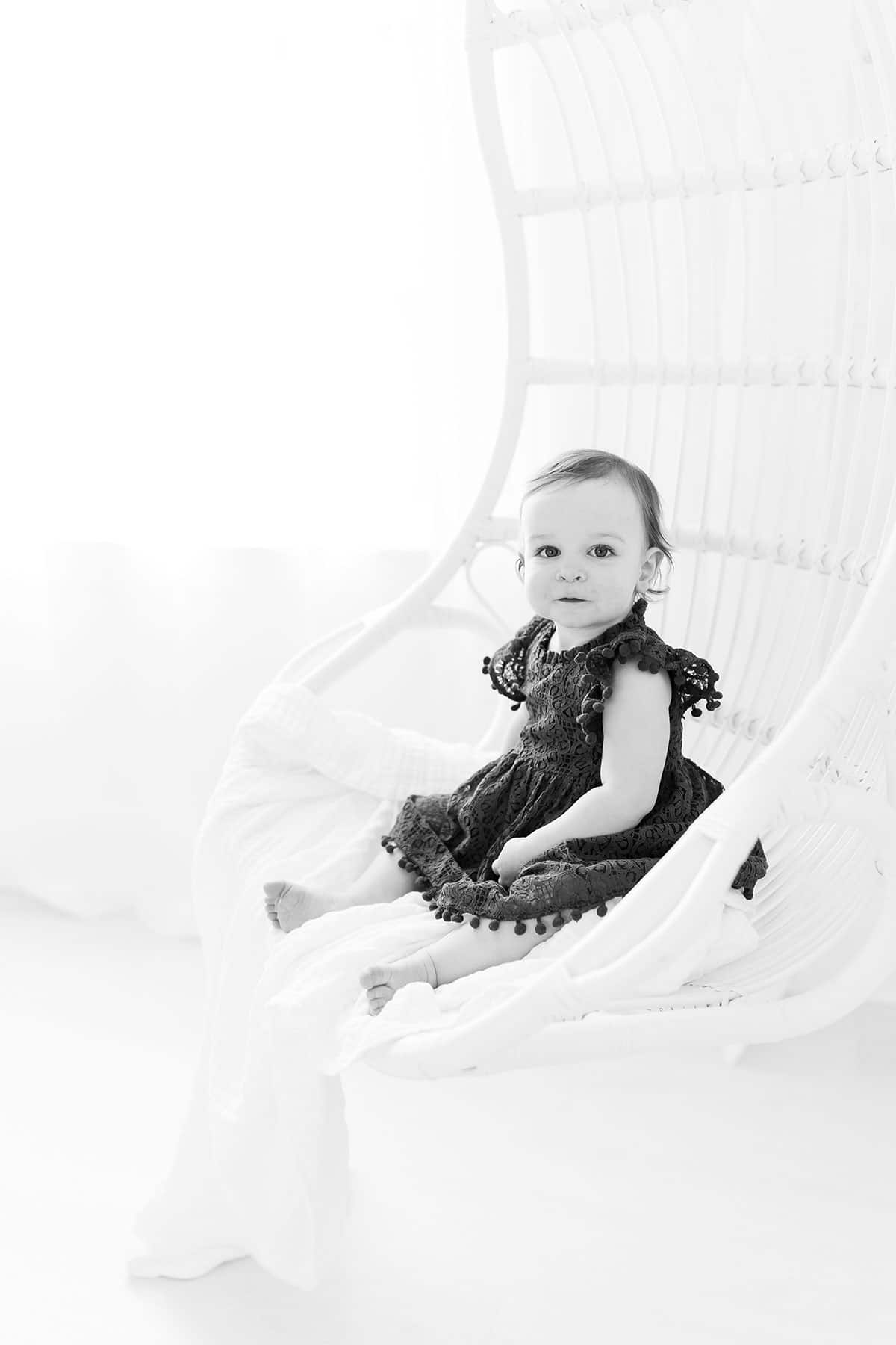 McKenzie sitting in a hanging swing chair