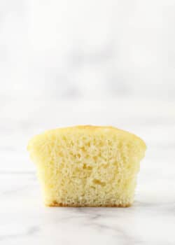 A moist vanilla cupcake cut in half to reveal its interior