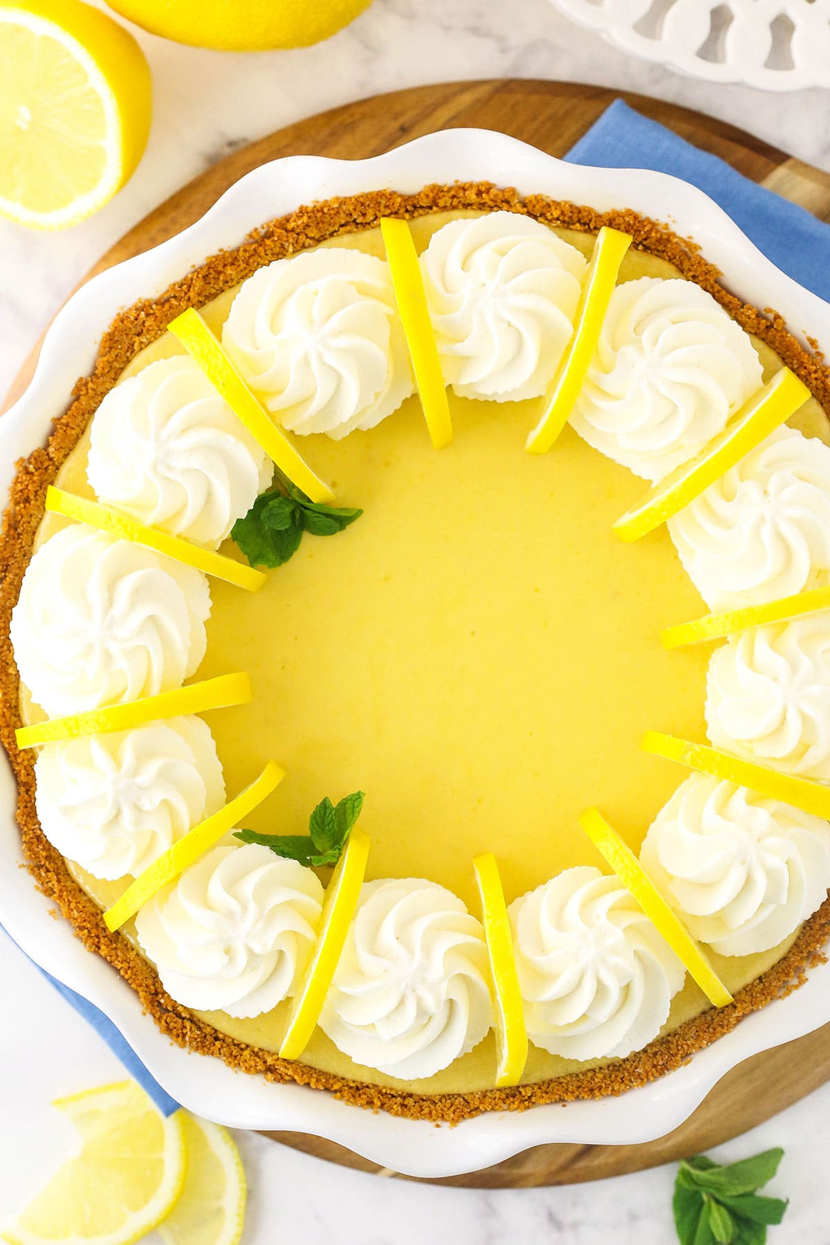 An overhead shot of a lemonade icebox pie on top of a pie plate with a wavy rim