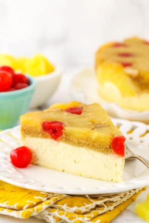 A slice of cheesecake on a plate, viewed from the side to show the texture of the layers.