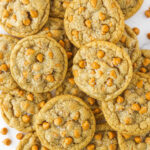 lots of butterscotch cookies piled onto white countertop