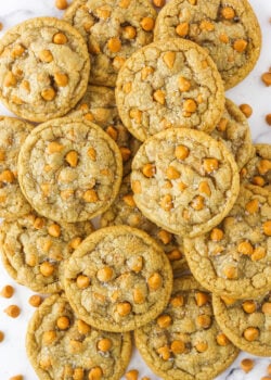 Overhead view of salted butterscotch cookies piled on a white countertop.