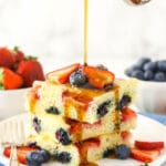 Three oven-baked flapjacks with pure maple syrup being poured over them