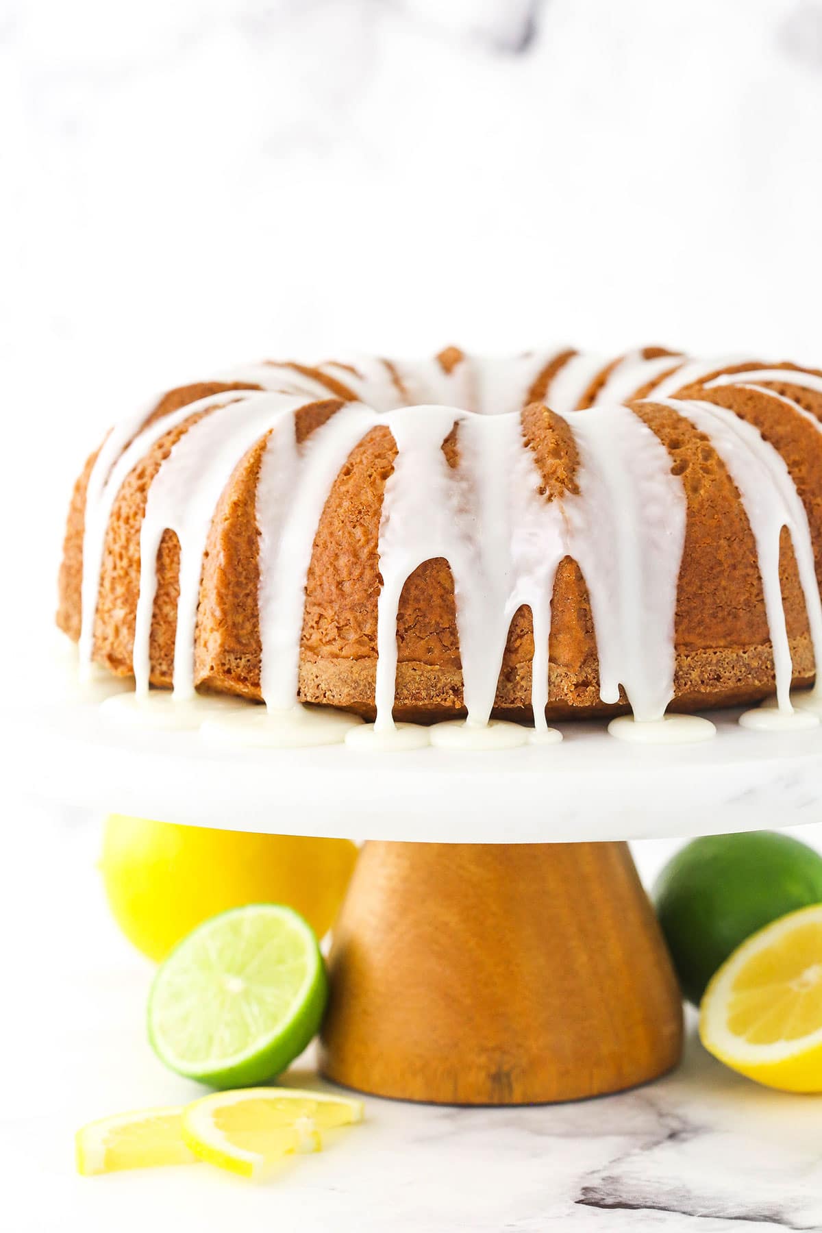 A lemon-lime bundt cake with homemade glaze dripping down the sides