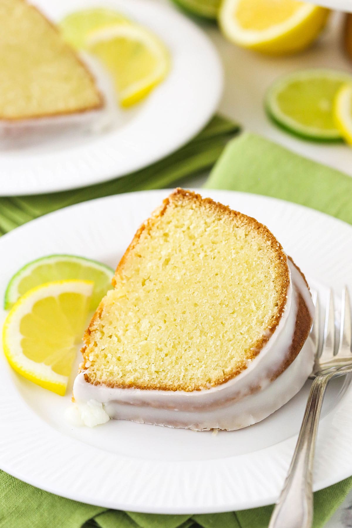 A piece of bundt cake with glaze on a white dessert plate