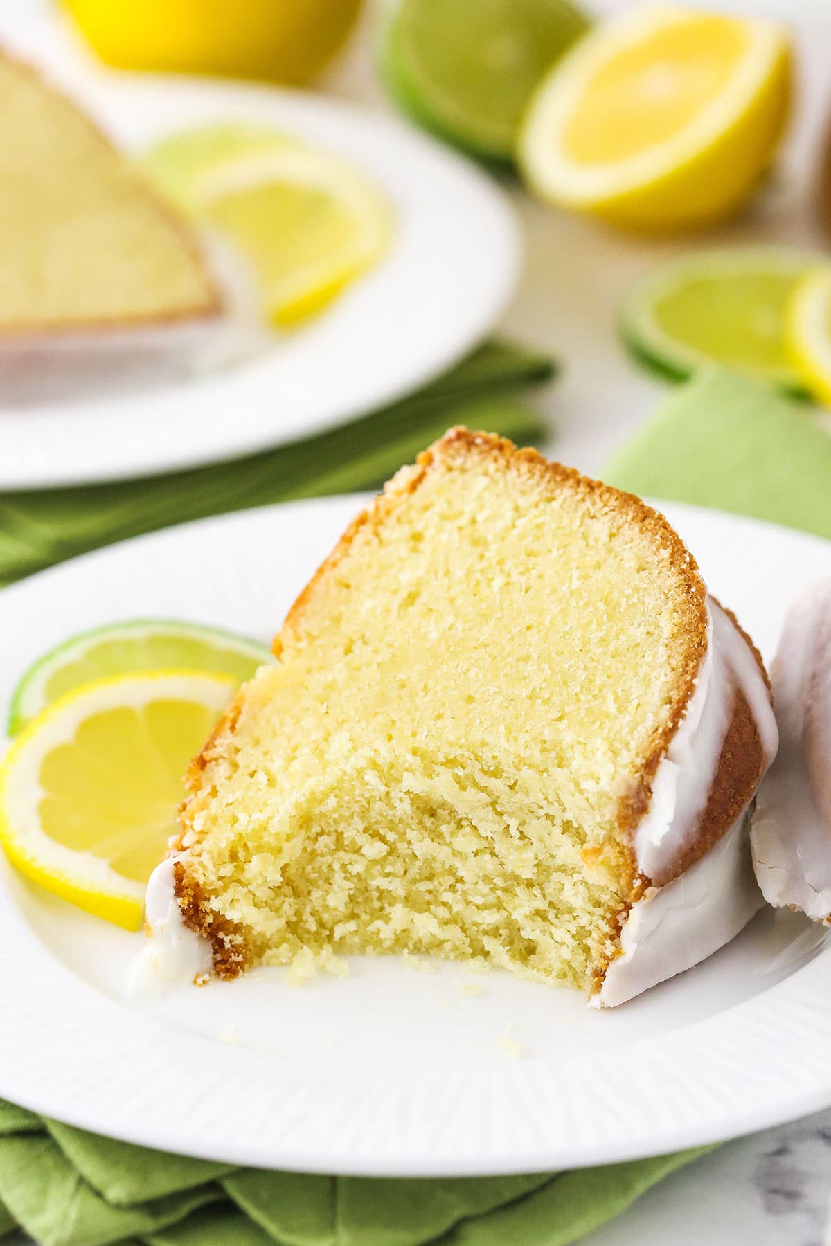 A slice of 7UP pound cake on a plate with one very large bite missing