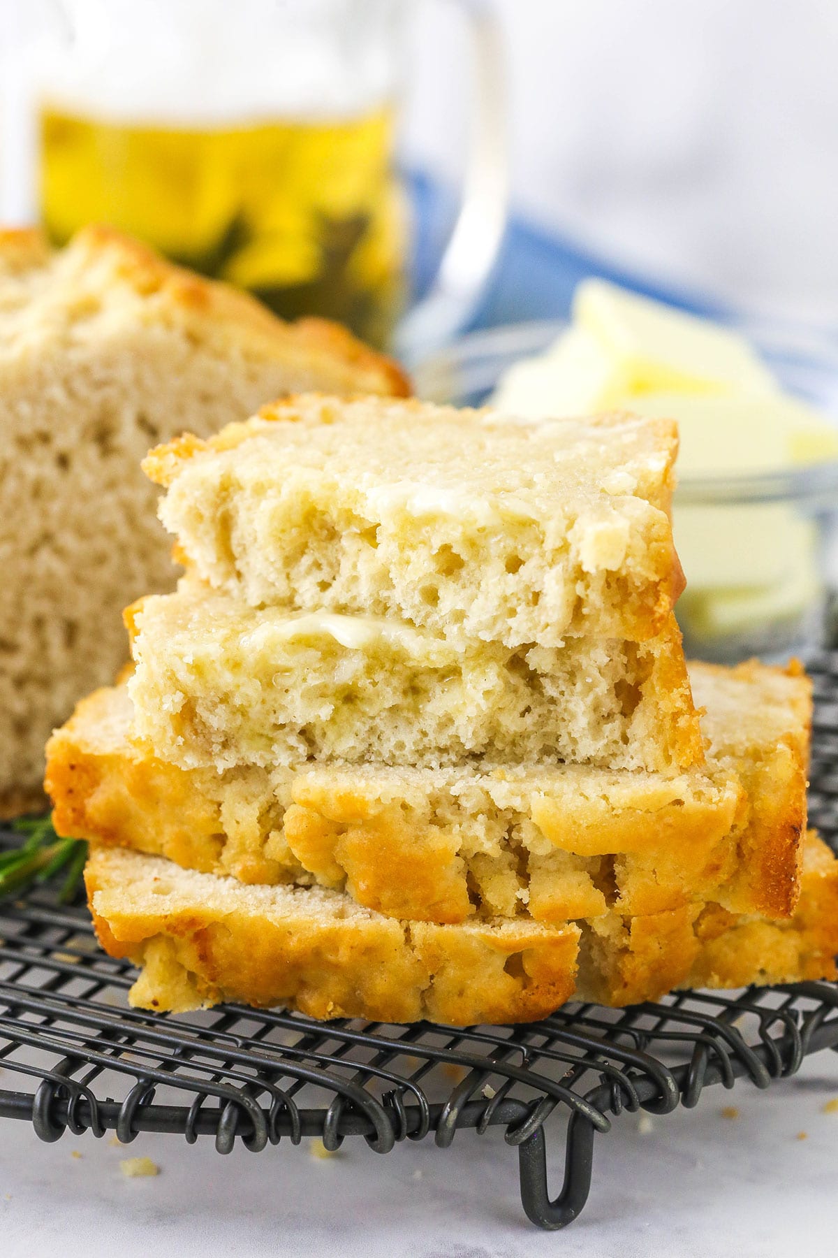 Two slices of beer bread stacked on top of each other with two more half slices on top of the stack