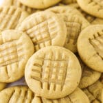 A bunch of homemade peanut butter cookies piled on top of one another