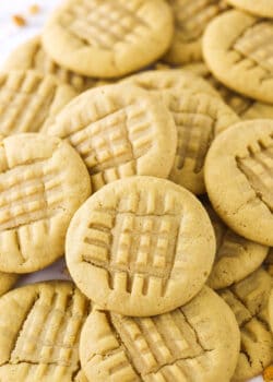 A bunch of homemade peanut butter cookies piled on top of one another