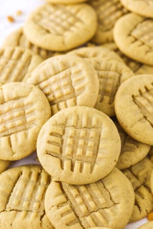 A bunch of homemade peanut butter cookies piled on top of one another
