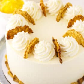 A frosted and decorated pineapple layer cake with dried fruit on top