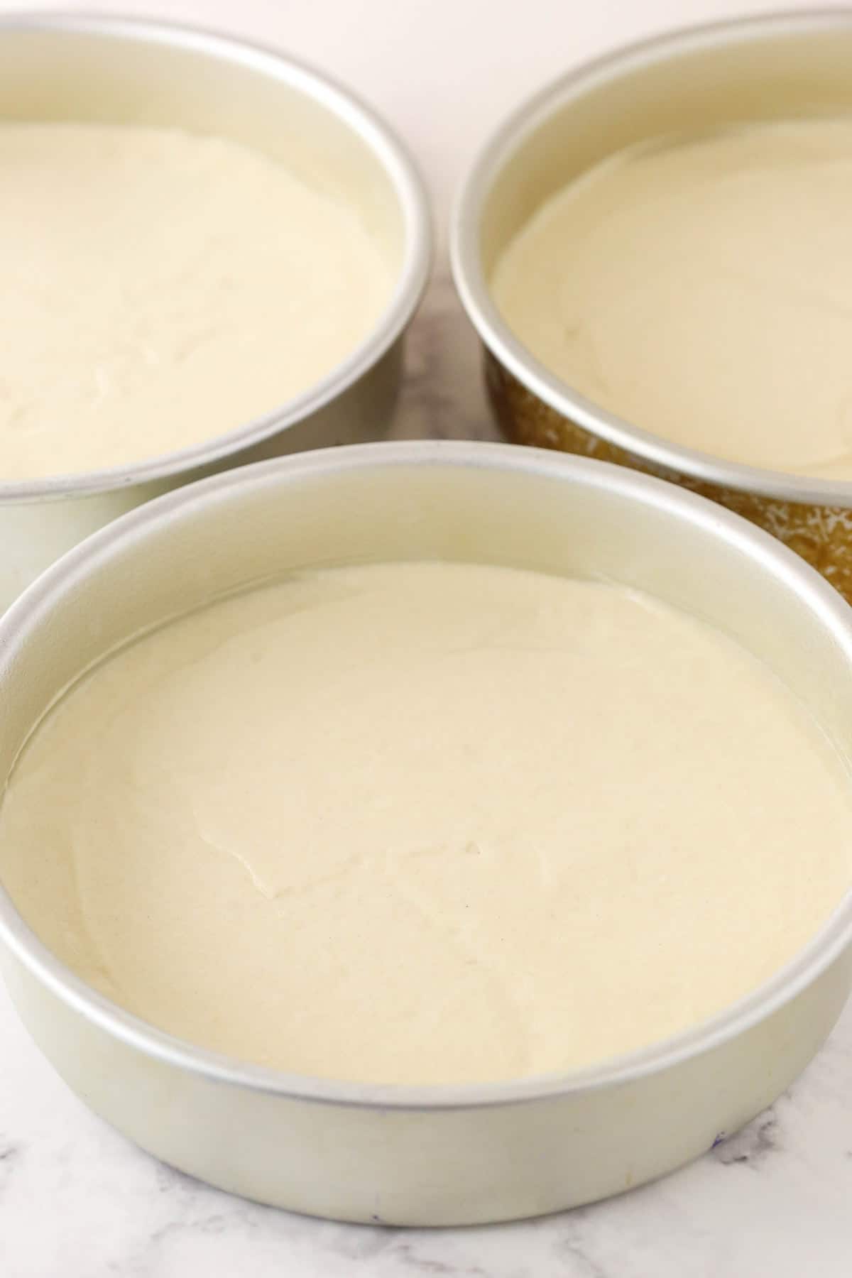 White-Cake-Step5- unbaked cake batter in cake pans