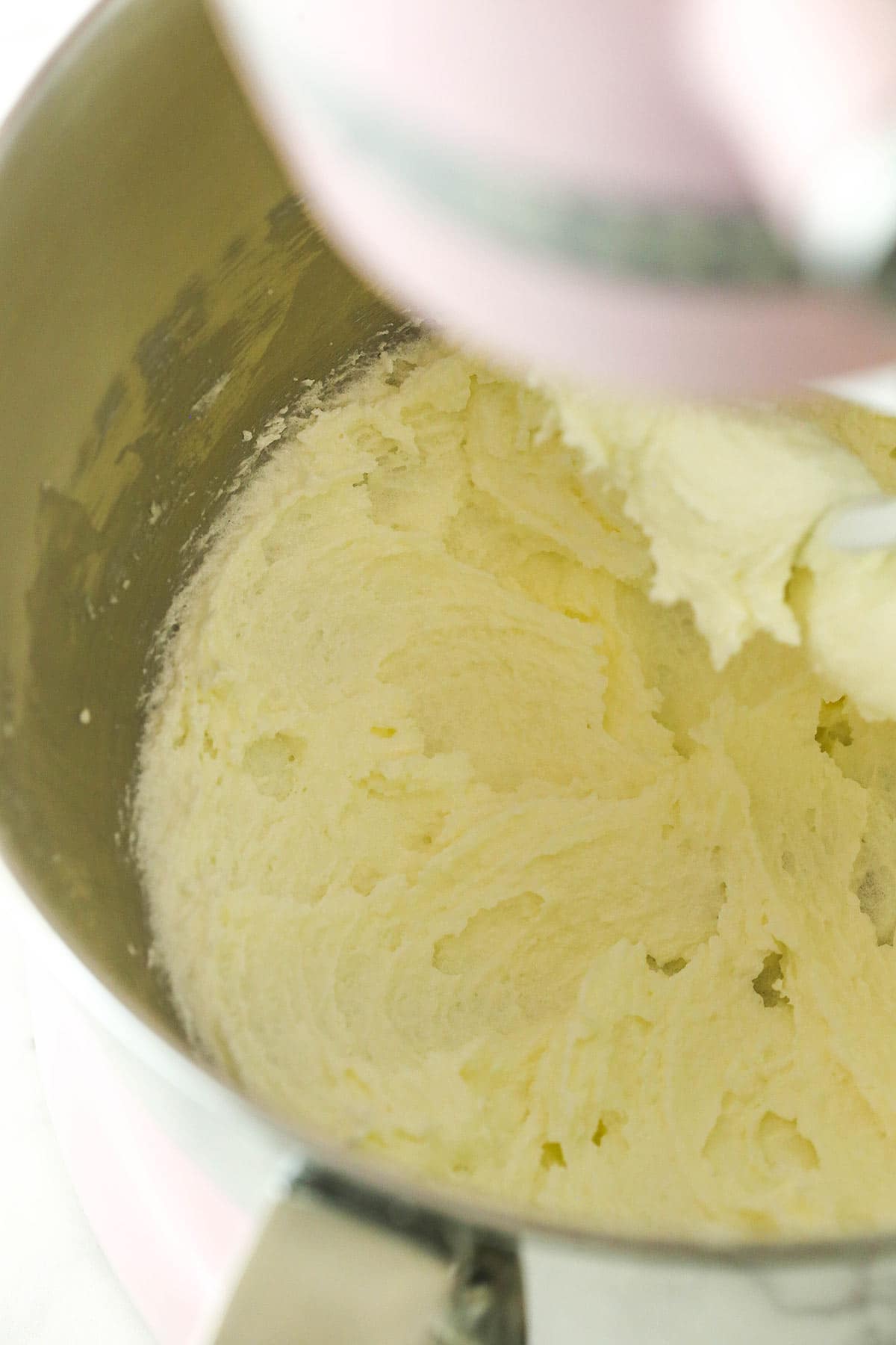 Creamed butter, oil and sugar inside of a large bowl fitted with an electric mixer