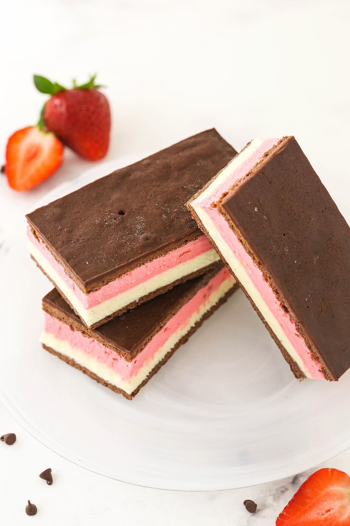 Three Neapolitan ice cream sandwiches on top of one dessert plate