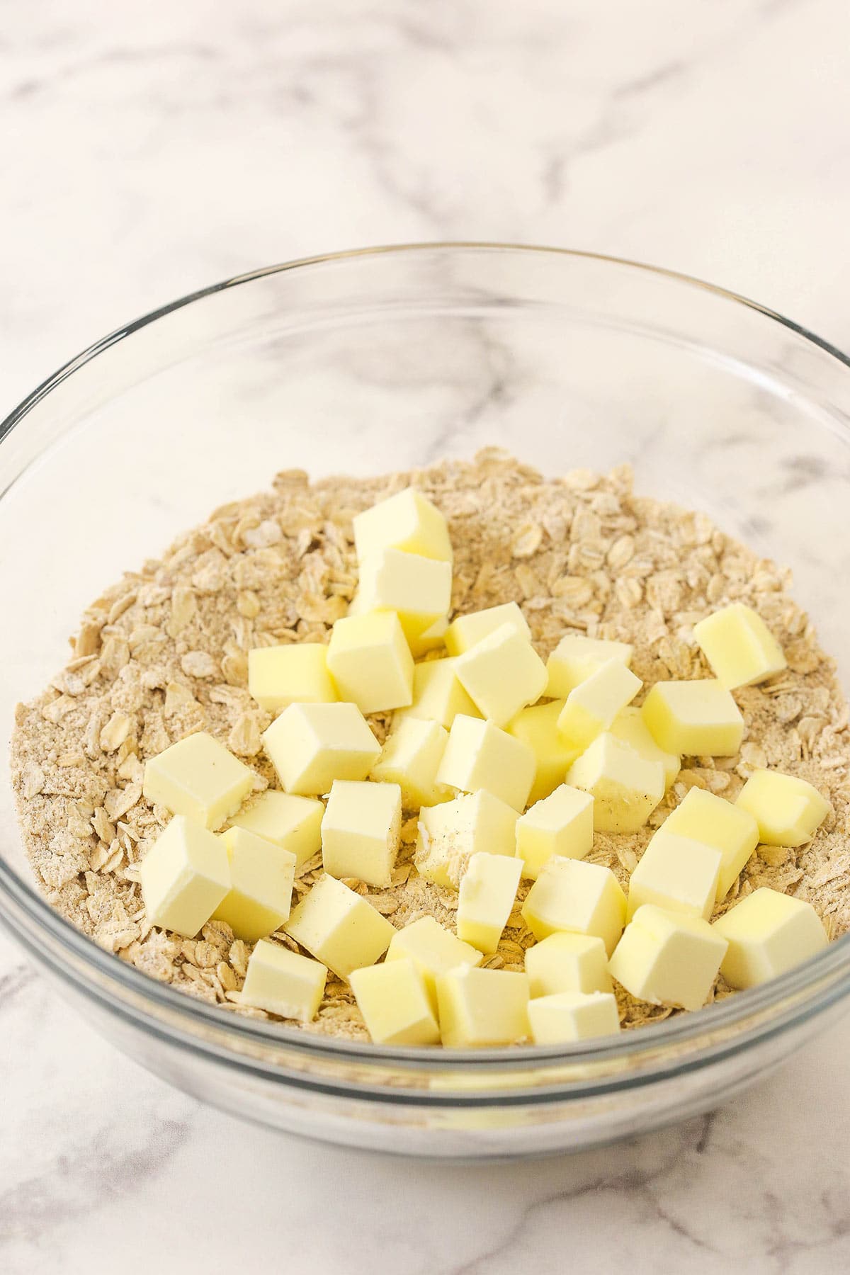 Chopped cold butter added to the dry ingredients.