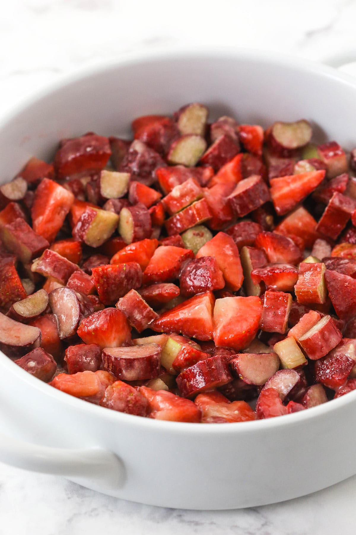 Strawberry and rhubarb mixture added to a baking pan