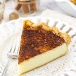 A piece of homemade pie on a small dessert plate with cutouts in the rim