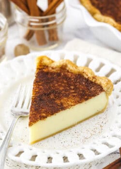 A piece of homemade pie on a small dessert plate with cutouts in the rim