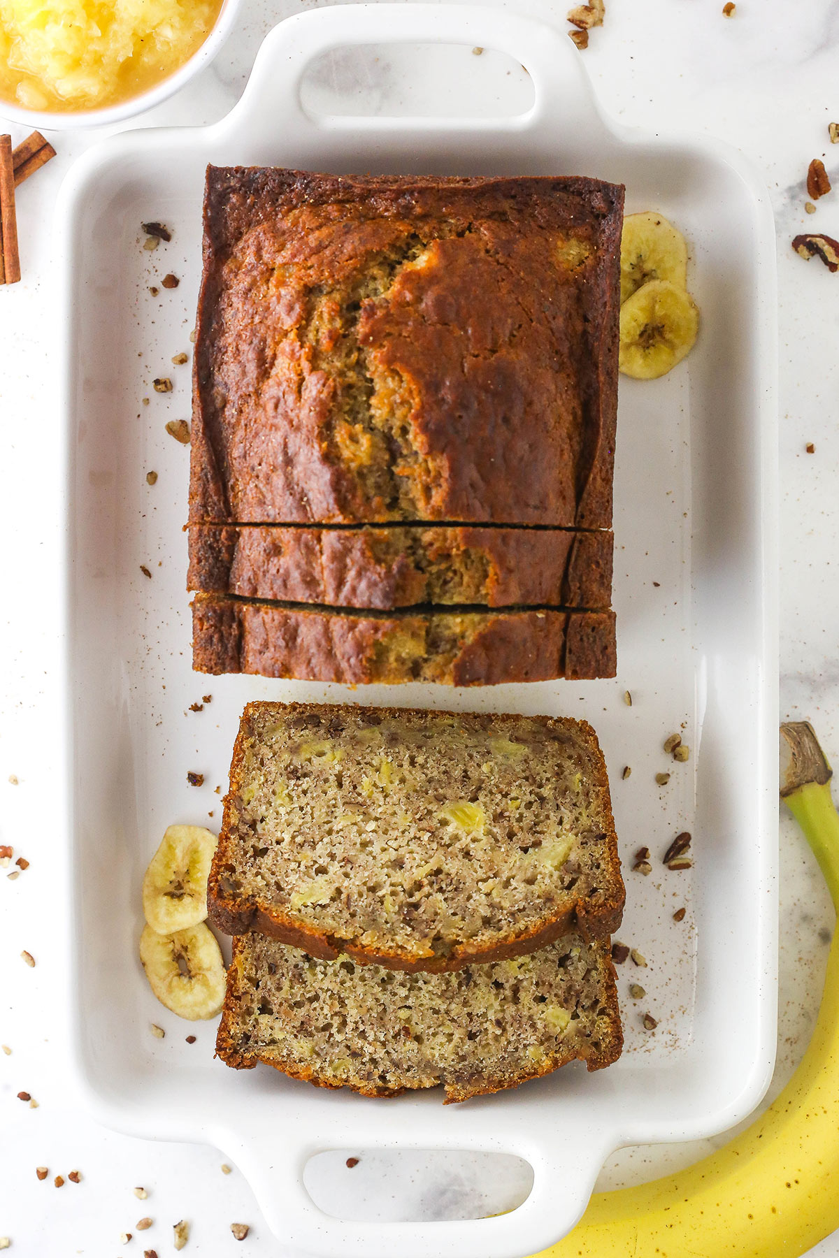 A loaf of hummingbird bread with four slices cut off of it