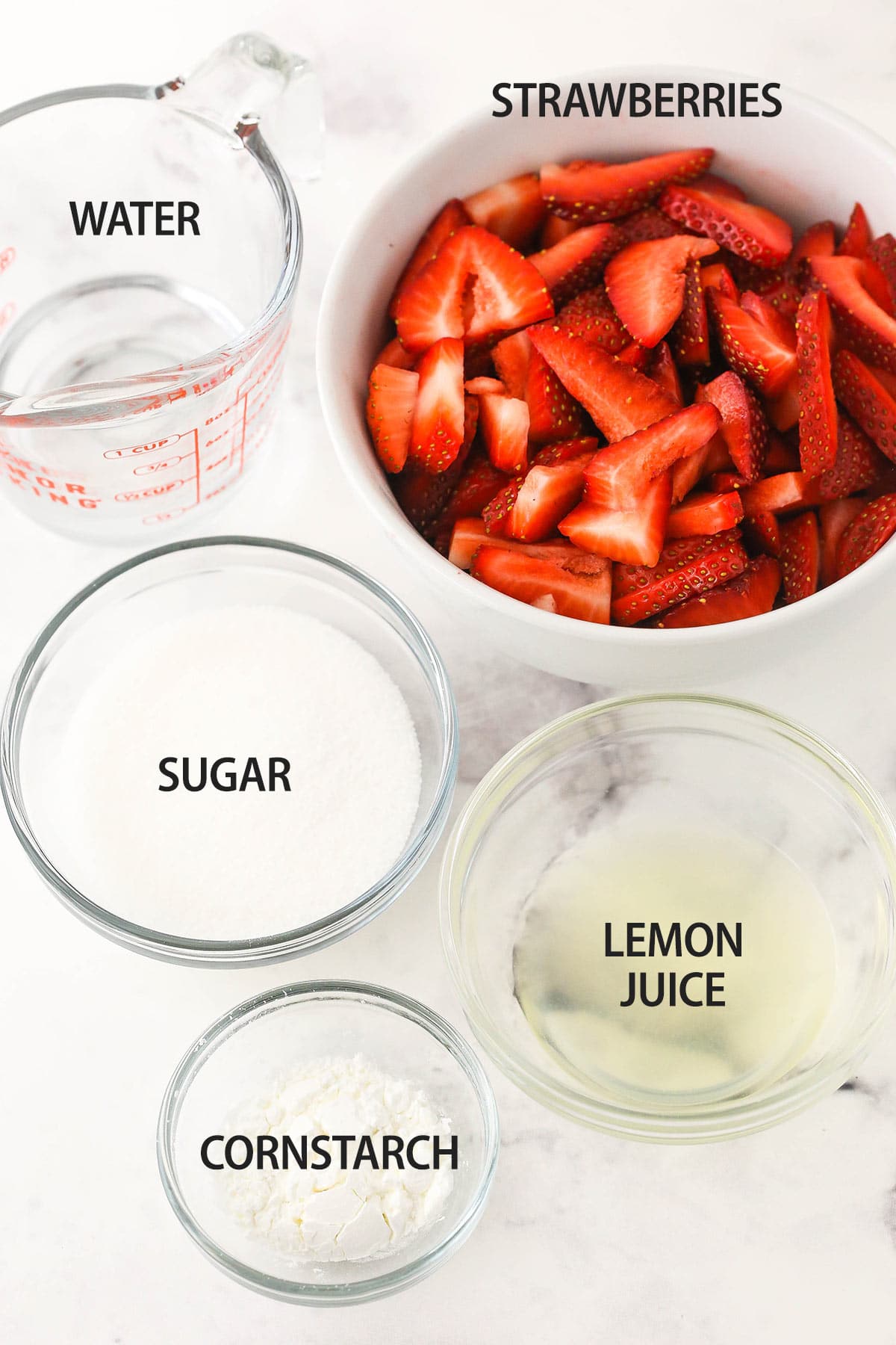 Strawberry sauce ingredients on marble table