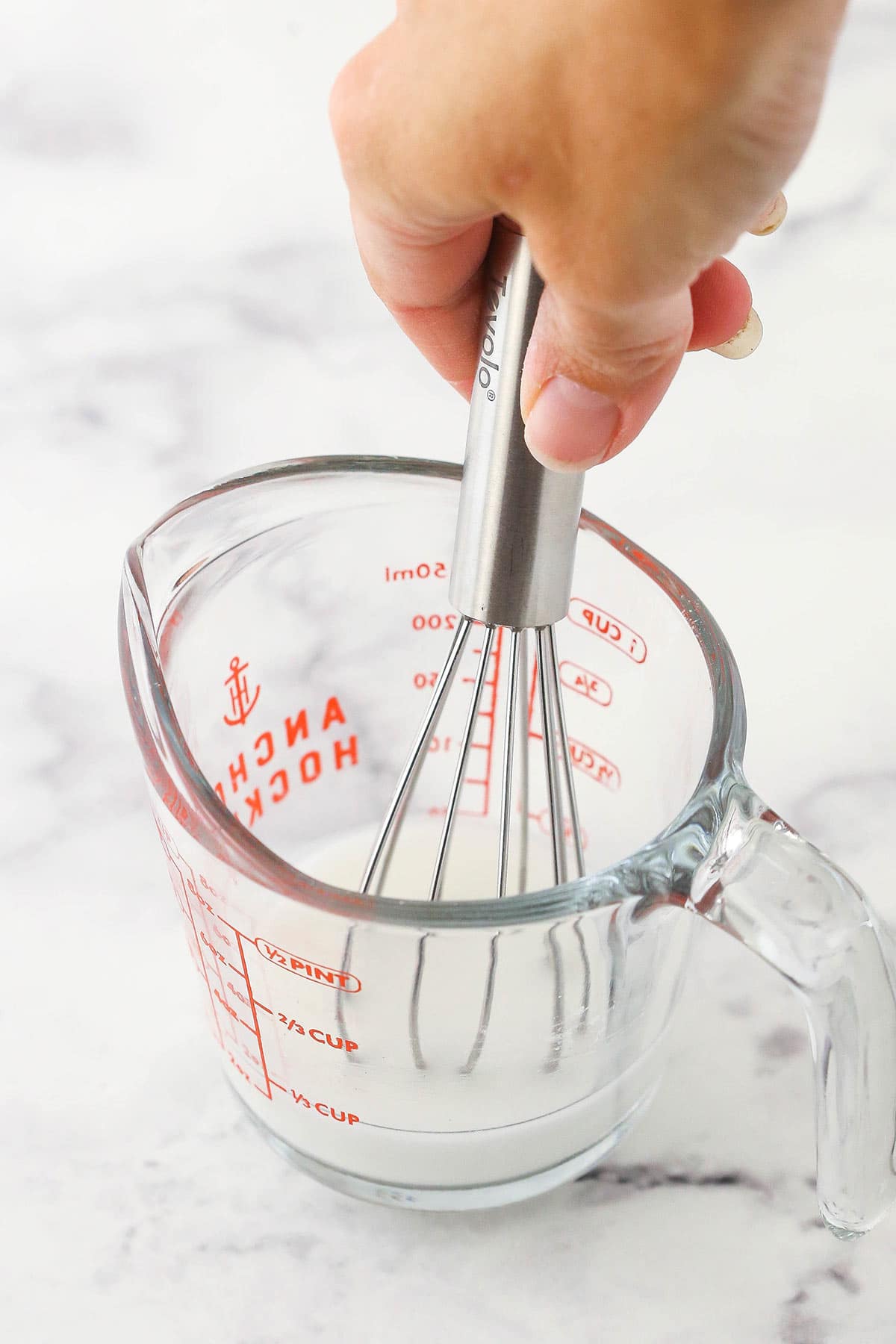 whisking water and cornstarch together in measuring cup