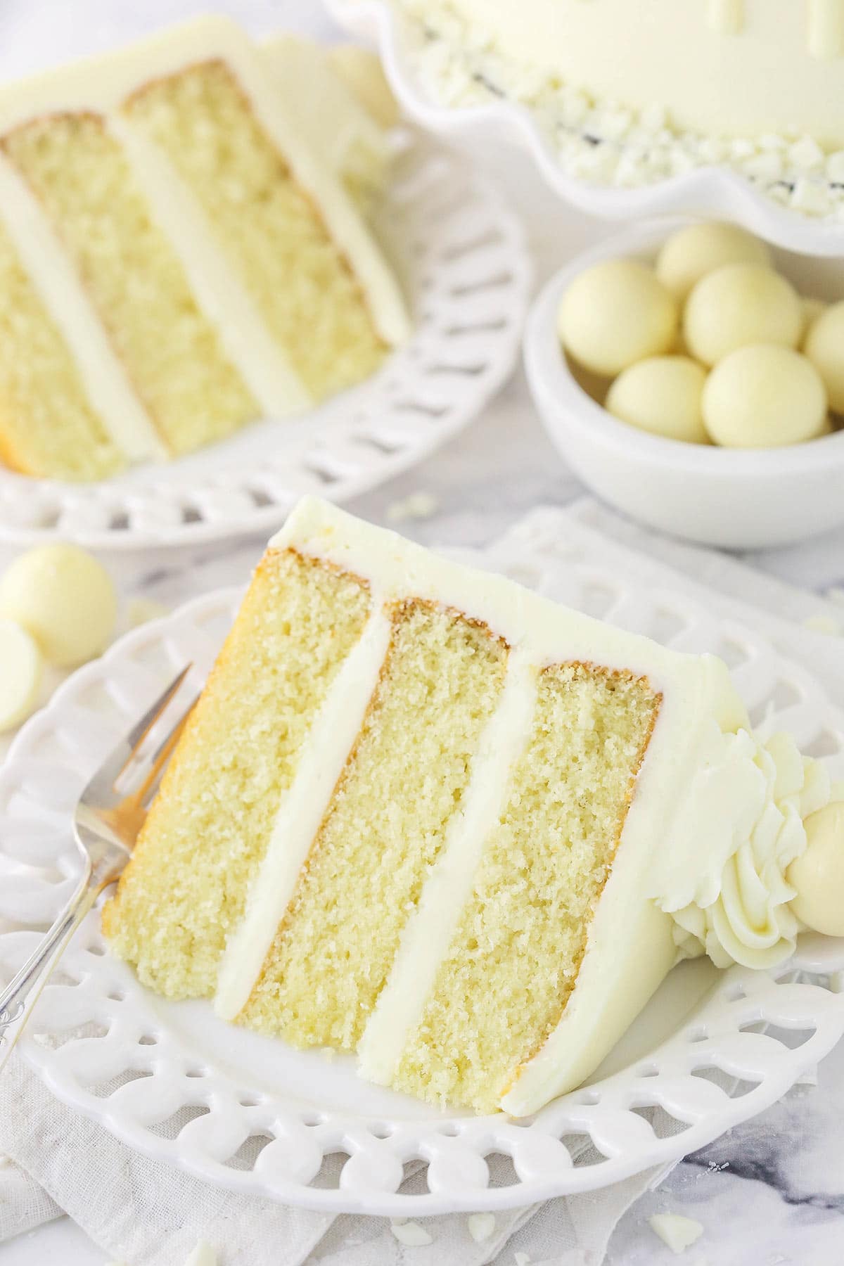 A plated slice of layer cake on top of a stack of two napkins