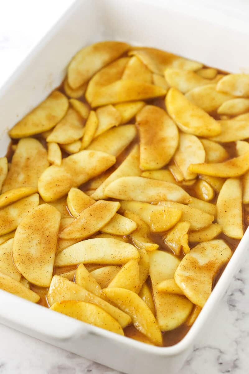 The pre-cooked filling layered evenly into a large white casserole dish.