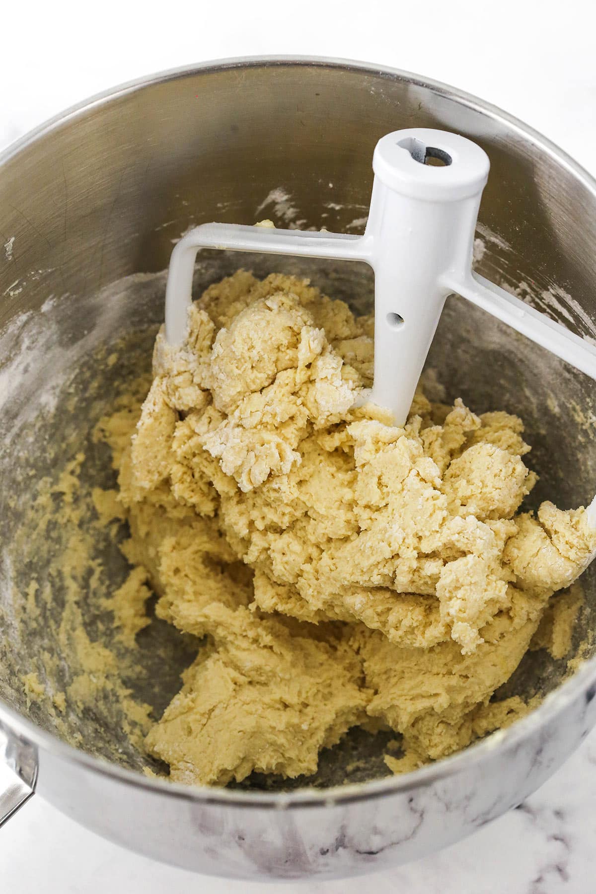 The dry ingredients being mixed into the wet ingredients for the cookie dough.