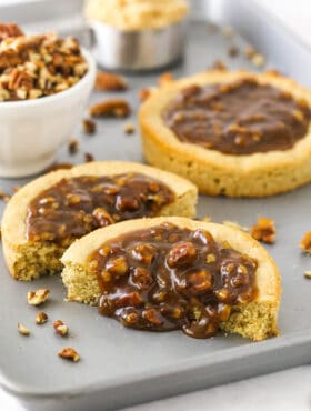 A pecan pie cookie cut in half with the homemade filling oozing out